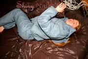 Katharina posing on a bed wearing a supersexy grey-blue downwear combination (Pics)