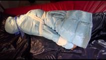 Lulu tied and gagged on a bed wearing a sexy blue shiny nylon rainpants and a iceblue PAMY downjacket (Video)