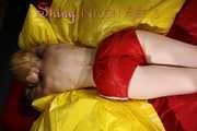 Sexy Sonja posing for you in a red shiny nylon shorts and a tshirts and then she takes it off and plays with the bedding (Pics)