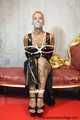 Miss Francine bound and gagged with layers of gags in a sexy PVC dress