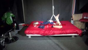 Sexy Sonja being tied and gagged with ropes and a clothgag on the ceiling overhead wearing a sexy blue shiny nylon shorts and a sexy blue/red rain jacket (Video)