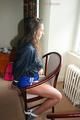 Stella tied and gagged on a chair wearing a blue shiny nylon shorts and a rain jacket (Pics)