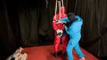 Sebastien breathplay in a red PVC jumpsuit.