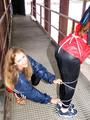 two of our archive girls in shiny nylon rainwear and bondage
