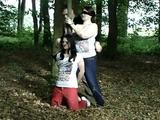 Two girls cuffed to a tree 2/2