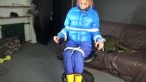 Sexy Pia being tied and gagged with ropes and a cloth gag on a hairdressers chair wearing a sexy blue shiny nylon rainpants and a lightblue downjacket (Video)