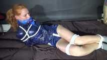 ***RONJA*** being tied and gagged on a sofa with ropes and a clothgag wearing a sexy blue shiny nylon shorts and a rainjacket (Video)