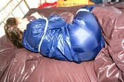 Stella tied and gagged in shiny nylon rainwear