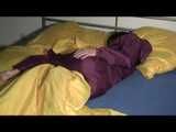 ENNI wearing a sexy purple shiny nylon rain suit lying in bed with yellow shiny nylon cloths lolling and posing (Video)