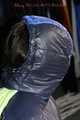 Sexy Mara wearing a black rain pants and a blue/black down jacket being tied, gagged and hooded with tape and clothgag (Pics)