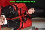 Sexy PIA wearing a sexy blue rainbib and a black/red shiny nylon rainjacket being tied, gagged and hooded on a chair with ropes and a ballgag (Pics)