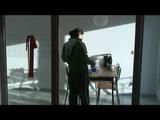 Enni with black shiny nylon shorts and rain pants and a rain jacket over naked skin smoking a cigarette (Video)