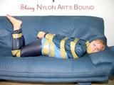 Leoni tied, gagged and hooded with tape wearing a sexy blue rainwear combination (Pics)