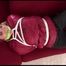 Jill tied, gagged and hooded on a sofa wearing sexy shiny black rain pants and an oldschool red rain jacket (Video)