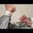 Pia tied and gagged in a shiny silver sauna suit bare feet on a bed (Video)