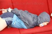 Jill tied, gagged and hooded with ropes on as sofa wearing a blue shiny nylon shorts and a blue oldschool rain jacket (Pics) 