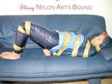 Leoni tied, gagged and hooded with tape wearing a sexy blue rainwear combination (Pics)