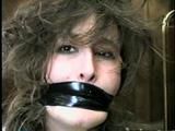 ERICA IS MOUTH STUFFED, WRAP TAPE GAGGED & BALL-TIED (D29-8)