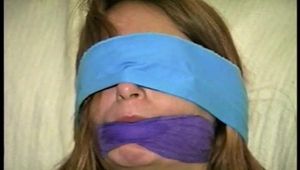 24 Yr OLD CRAFTER IS BLINDFOLDED, CLEAVE GAGGED WITH WRAP AROUND VET TAPE, BALL-TIED,CROTCH ROPED, BAREFOOT, TOE-TIED, GAG TALKING THROUGH A WET DROOL GAG, HOPS AROUND WEARING A SEXY BIKINI (D70-9)