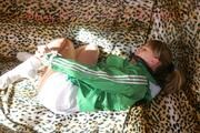 Leonie tied and gagged on a sofa wearing a white shiny nylon shorts and a green rain jacket (Pics)