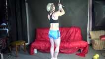 Watching ***NEW MODELL COURTNEY*** wearing a sexy lightblue shiny nylon shorts and a black top being tied and gagged overhead with ropes and a ballgag (Video)