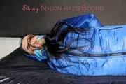 Lucy wearing sexy lightblue downwear tied and gagged with ropes and cloth gag on a bed (Pics)