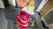 Alice bound and gagged in a nylon Rainsuit