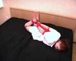Barefoot nurse Gatitta tied up with a red rope (video)