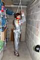 Nicole in an silver shiny PVC sauna suit tied and gagged in an cellar (Pics)