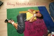 Stella tied and gagged on the floor wearing a shiny nylon rain pants (Pics)