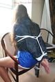 Stella tied and gagged on a chair wearing a blue shiny nylon shorts and a rain jacket (Pics)