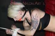 Watching ***NEW MODELL COURTNEY*** wearing a sexy lightblue shiny nylon shorts and a black top being tied and gagged overhead with ropes and a ballgag (Pics)