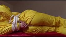 Jill tied, gagged and hooded on a bed wearing wonderful shiny yellow rainwear (Video)