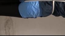 Pia tied and gagged over head in a laundry wearing a supersexy black leggins and a blue shiny nylon adidas shorts as well as a blue rain jacket (Video) 