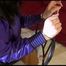 Mara tied, gagged and hooded with cable tie on a chair wearing a leggins and a shiny nylonshorts over it as well as a purple rain jacket (Video)