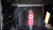 ***SEXY MARA*** wearing a supersexy black shiny nylon pants and a red shiny nylon down jacket with a coat being bound overhead with ropes and a ball gag (Video)