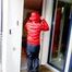Marlin posing on a balcony wearing sexy black shiny nylon rainpants and a red down jacket (Pics)