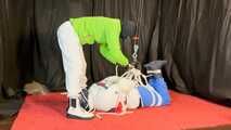 Sebastien breathplay in 2 down jackets is hanging tied the in a hogtie.