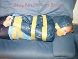 Leoni tied, gagged and hooded with tape wearing a sexy blue rainwear combination (Pics)