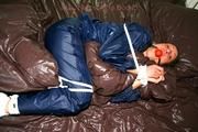 Stella tied and gagged in shiny nylon rainwear