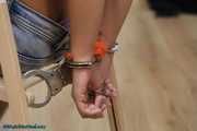 Hot jeans girl cuffed on a chair