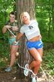 Jill ties and gagges an archive girl outdoor on a tree both wearing shiny nylon shorts and shirts (Pics)