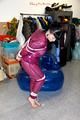 Jill tied and gagged in a semi-transparent purple PVC suit