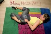 Stella posing in a living room wearing supersexy rainwear (Pics)