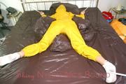 Stella tied and gagged on a bed wearing a supersexy yellow rainwear combination (Pics)