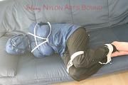 Katharina tied, gagged and hooded (breath control) on a sofa wearing sexy shiny nylon rainwear (Pics)