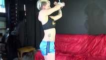 Watching ***NEW MODELL COURTNEY*** wearing a sexy lightblue shiny nylon shorts and a black top being tied and gagged overhead with ropes and a ballgag (Video)