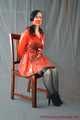 Bound in PVC minidress and red raincoat