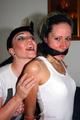 Petra tied and gagged by Jill in shiny shorts