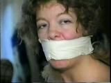 25 YR OLD CHARLENE IS WRAP GAGGED & CHAIR TIED TO A CHAIR WITH WHITE CLOTH MEDICAL TAPE (D47-14)